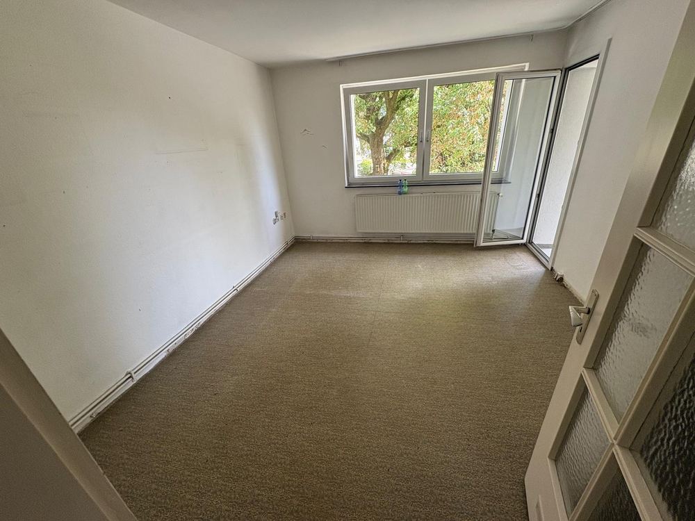 Leeres Zimmer mit Teppichboden nach der Räumung
